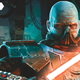 Darth Malgus, the half-masked, bald Sith Lord villain from Star Wars: The Old Republic, glowers as he ignites his red lightsaber.